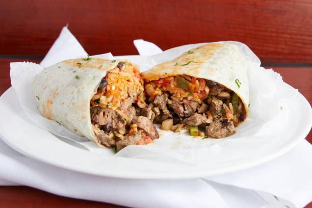 Steak Burrito A mouth watering and delicious Steak Burrito ready to have a bit taken burrito photos stock pictures, royalty-free photos & images