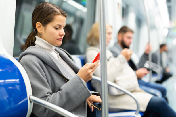 istock Girl with phone in metro car 1217651171
