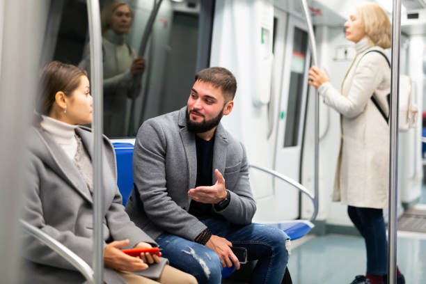istock Guy enjoying conversation with woman in subway train 1217651176
