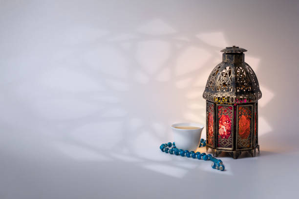 istock Ramadan Lantern, prayer beads beads and Arabic coffee, with arabesque shadow on background. 1217651388