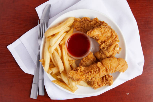 istock Fried Chicken Strips and French Fries 1217651420