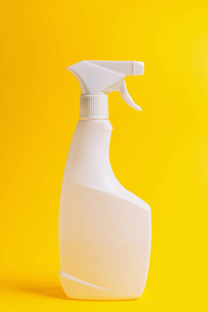 istock Bottled cleaners, disinfectants, sponges on a yellow background, side view 1217652030