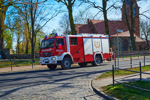Grossziethen, Germany - April 6, 2020: Fire engine of the volunteer fire brigade on the way to a deployment site.