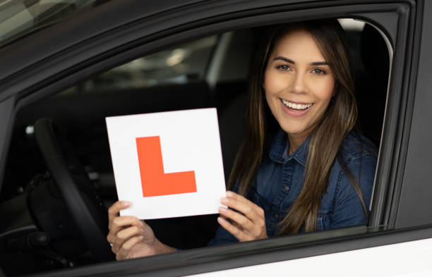 istock Happy woman driving a car using L plates 1217652674