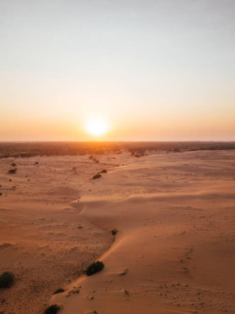 Aerial Lompoul Desert In Senegal Dunes from Drone The Lompoul desert is a small desert (about 18 km2) located 145 km south of Saint-Louis, Senegal. It is characterized by orange sand dunes senegal beach stock pictures, royalty-free photos & images