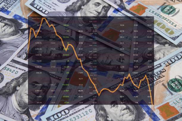 istock Financial figures with downward graph over hundred dollar background 1217653457