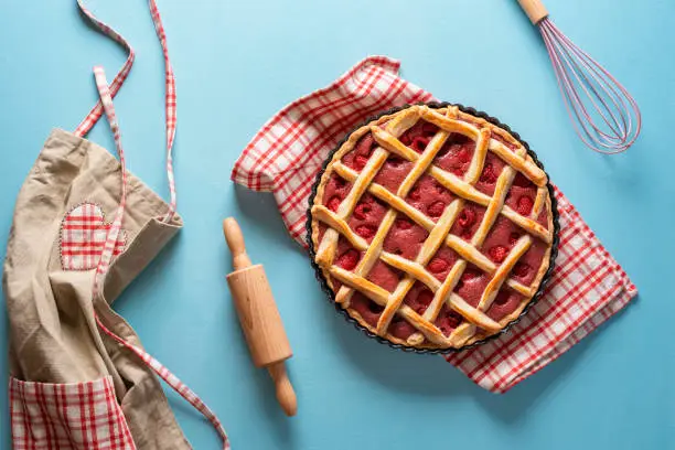 Photo of Raspberry pie with a lattice crust. Sweet pastry baking concept