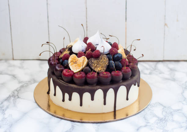 istock Vanilla cheesecake decorated with melted dark chocolate, fresh berries, cherries, chocolate hearts and meringues. 1217653748