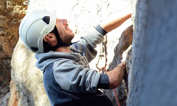 istock Sportsman mountain climbing against blye sky. 1217654831