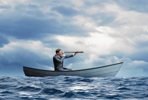 istock Stranded Businessman In Row Boat Searches For Help 1217655946