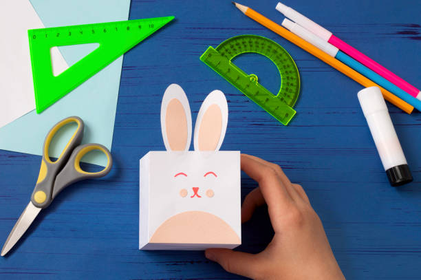 istock Child makes box for sweets in form of Easter Bunny. Step 8 1217658934