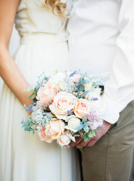 istock young engaged couple keeping the wedding bouquet 1217658977