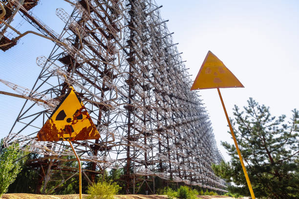 Former military Duga radar system and radioactive signs in Chernobyl Exclusion Zone, Ukraine Former military Duga radar system and radioactive signs near ghost town Pripyat in Chernobyl Exclusion Zone, Ukraine pripyat city photos stock pictures, royalty-free photos & images