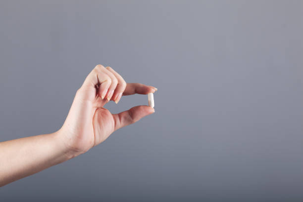 istock woman hand pills 1217659182