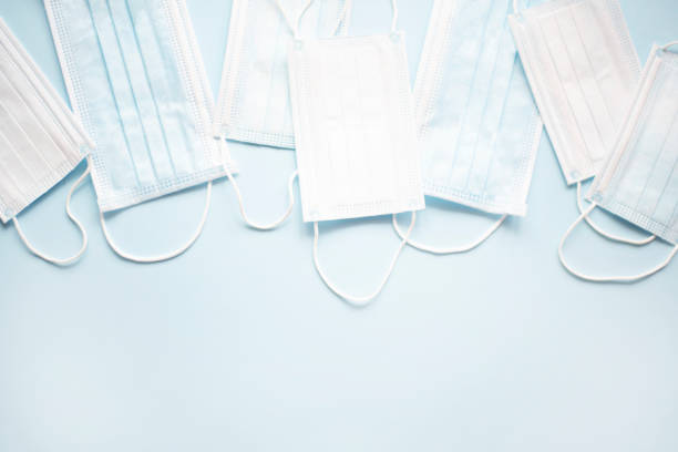 istock Medical masks on a light blue background. 1217660732