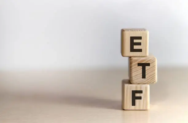 Photo of ETF - Exchange Traded Fund text on wooden cubes, on white background