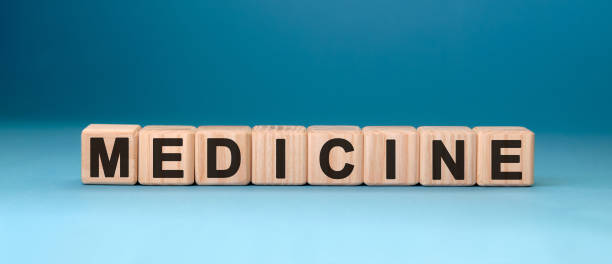 istock MEDICINE word cube on a blue background. Medical concept. 1217663680