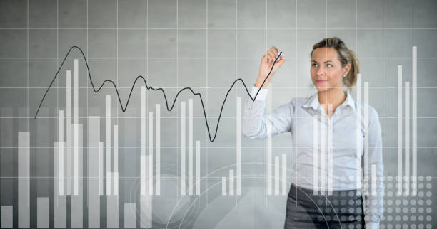 business woman drawing a growth graph at the office - diagram business writing women imagens e fotografias de stock