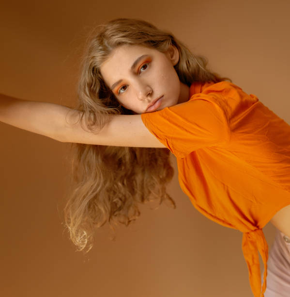 istock Beautiful woman in orange clothes 1217666451
