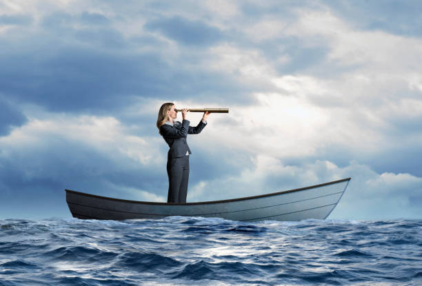 istock Stranded Businesswoman In Row Boat Searches For Help 1217667707