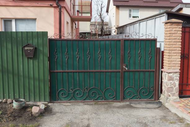 istock closed green private metal gate 1217668996