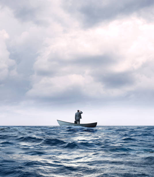 istock Stranded Businessman In Row Boat Searches For Help 1217670566