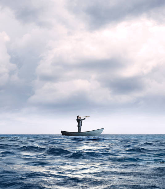 istock Stranded Businessman In Row Boat Searches For Help 1217670573