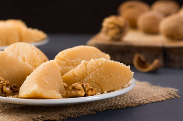 turkish famous traditional homemade flour halva served with walnut in plate on rustic background, turkish dessert for holy night or funeral - sweet food imagens e fotografias de stock