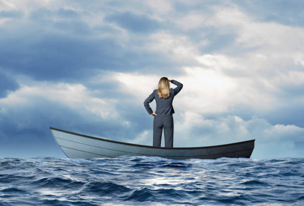 istock Stranded Businesswoman In Row Boat Searches For Help 1217673579