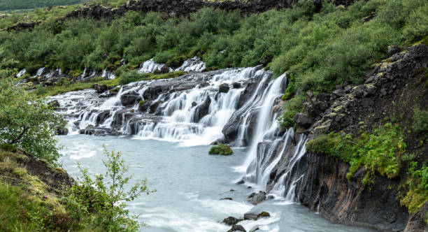 Hraunfossar waterfall in western Iceland Hraunfossar waterfall in western Iceland at a cloudy day hraunfossar stock pictures, royalty-free photos & images