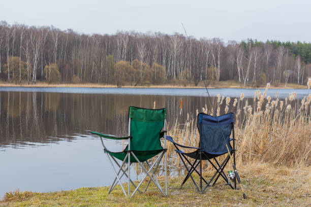 istock two armchairs and spinning by the lake 1217677630
