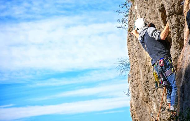 istock Sportsman mountain climbing against blye sky. 1217678631