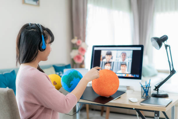 istock Asian woman teacher teaching solar system via video conference e-learning and cheerful elementary school student looking at globe, Homeschooling and distance learning ,online ,education and internet. 1217682403
