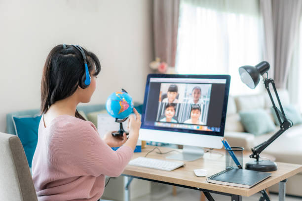 Asian woman teacher teaching geography via video conference e-learning and cheerful elementary school student looking at globe, Homeschooling and distance learning ,online ,education and internet.