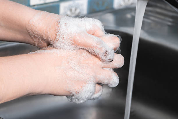 istock A woman washes and disinfects her hands with soap. Step-by-step instructions for handwashing. Coronavirus protection. 1217687378