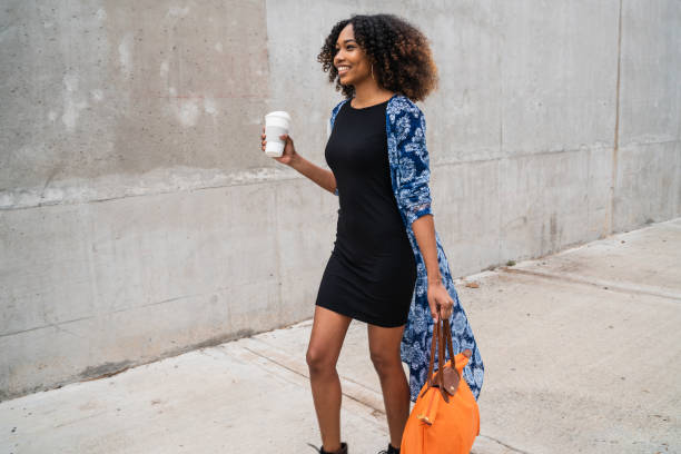 istock Afro american woman walking with coffee. 1217689276