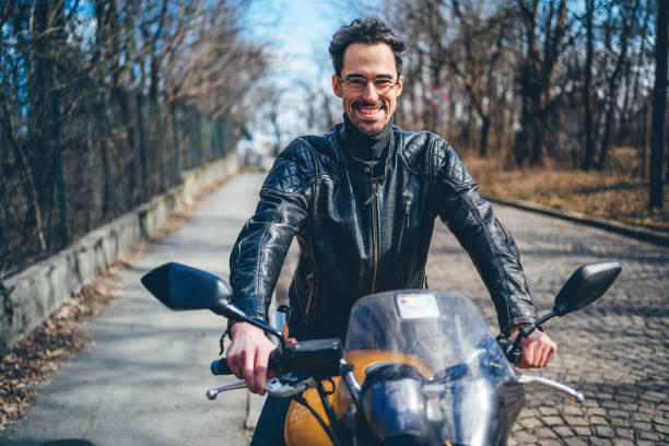 istock Caucasian man with motorbike 1217689290