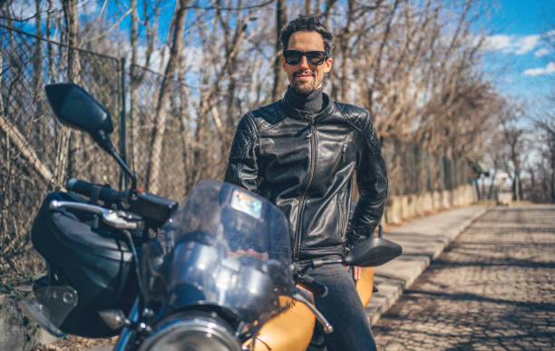 istock Man in leather jacket on motorcycle 1217690157