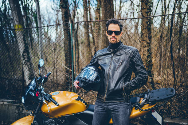 istock Man with motorbike 1217690239