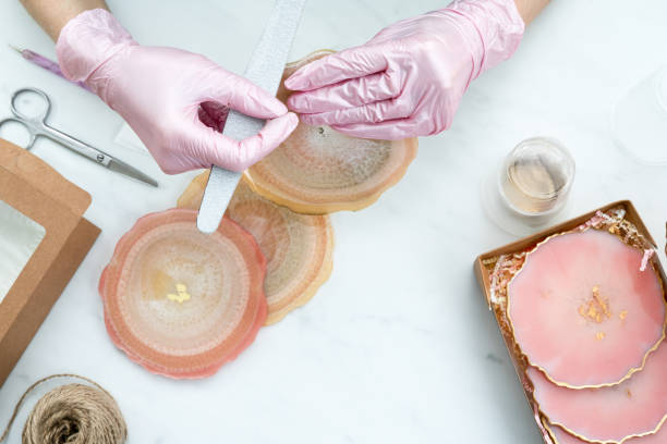 istock Creativity and craft. A young girl creates coasters from resin. Gift wrapping. Decorative packaging. Idea for business. Remote work, work at home. Art coasters. 1217691904