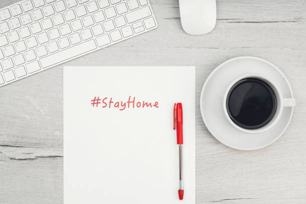 istock White keyboard and mouse. Remote work, self-isolation, work at home, quarantine. The inscription stay home. 1217692529