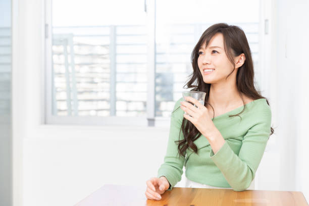 istock asian woman who drinks water 1217696509