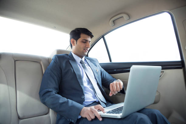 business man in car back seat - stock photo Businessman, Car, Men, Taxi, cab stock pictures, royalty-free photos & images