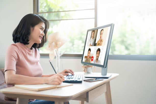 asian business woman talking to colleague team about plan in video conference. group of multiethnic business people using computer for online meeting in video call conference. smart working from home. - escape from it all fotos imagens e fotografias de stock