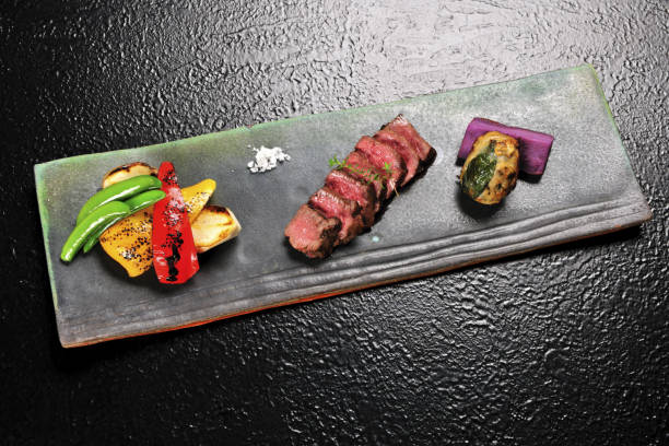 Various food served in the plate on the black table