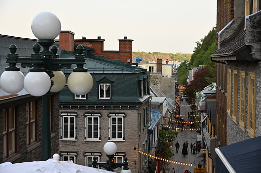 Basse-Ville de Quebec, the charming street of Petit-Champlain, framed by white windows and a beautiful five-globe streetlamp