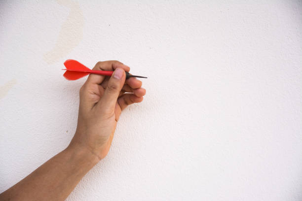 istock Hands holding dart arrow on white background 1217709041