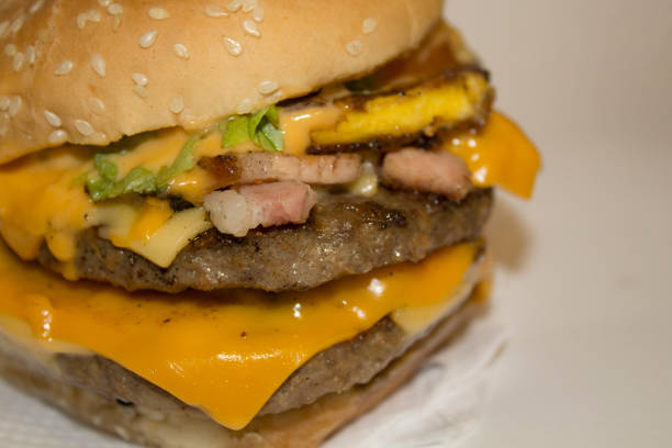 ugly fat sandwich. Big real homemade burger with egg and four meat on a plate.