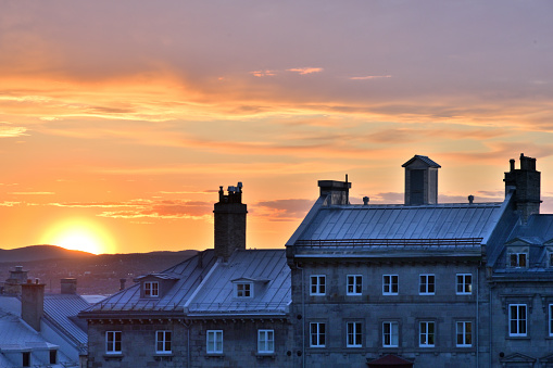 sunset view over old Quebec, across the tin roofs defining the horizon