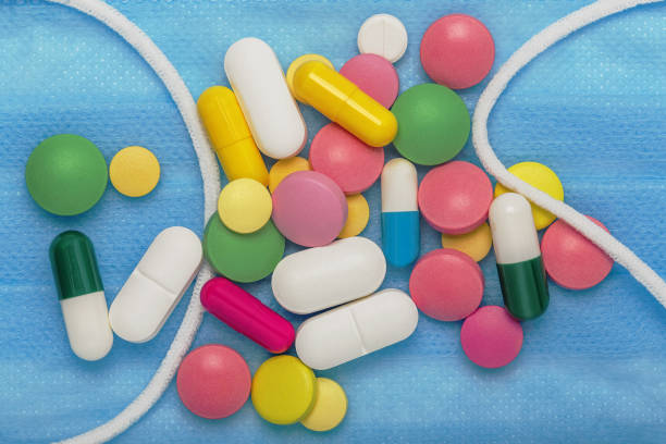 istock pills and  medical mask  for virus and flu 1217715244